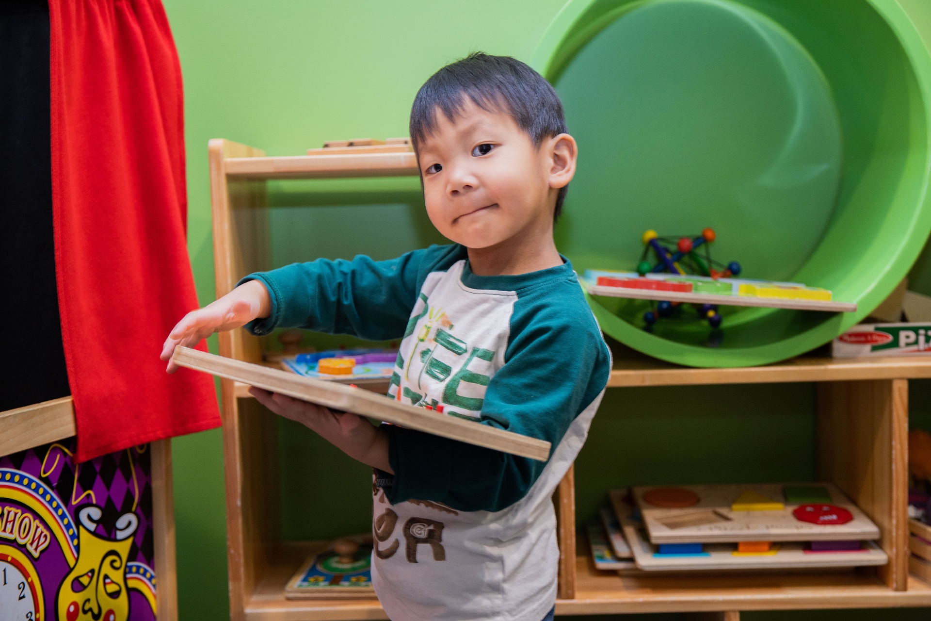 Camper exploring a tabletop activity in the camp play area